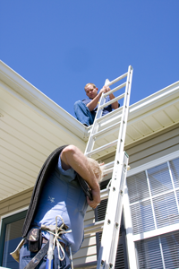 San Jose roofer steadies ladder for coworker